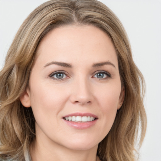 Joyful white young-adult female with medium  brown hair and green eyes