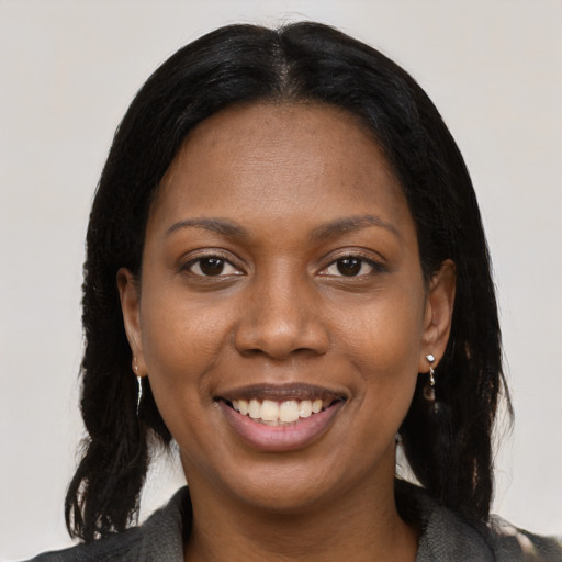 Joyful black young-adult female with medium  black hair and brown eyes