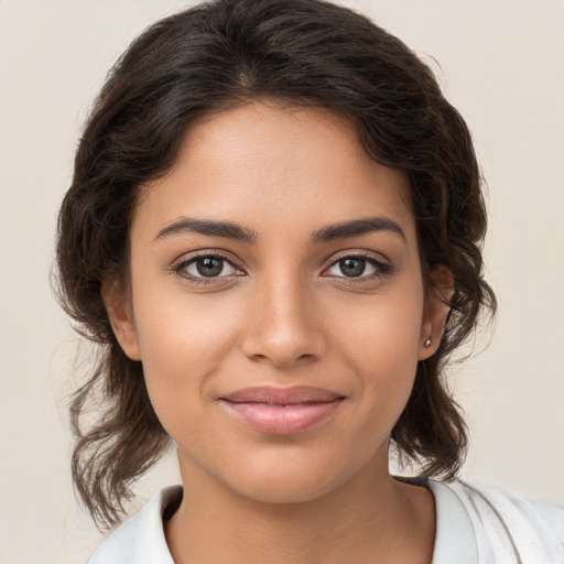 Joyful white young-adult female with medium  brown hair and brown eyes