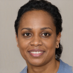 Joyful black adult female with short  brown hair and brown eyes