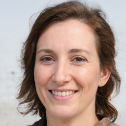 Joyful white adult female with medium  brown hair and brown eyes