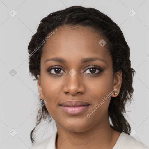 Joyful black young-adult female with long  black hair and brown eyes