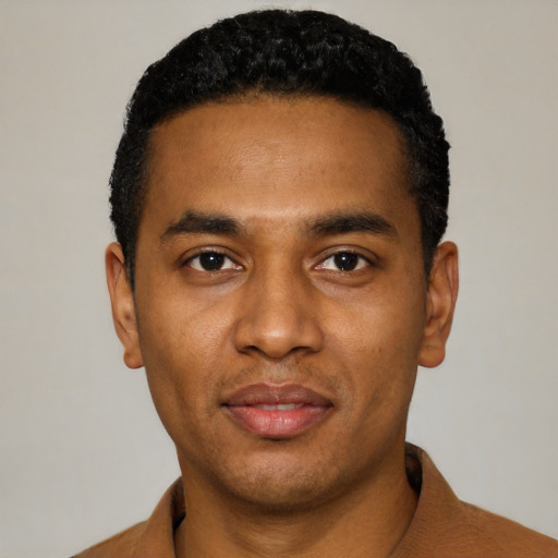 Joyful black young-adult male with short  black hair and brown eyes