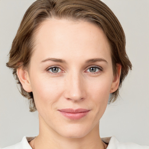 Joyful white young-adult female with medium  brown hair and grey eyes