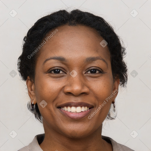 Joyful black adult female with short  brown hair and brown eyes