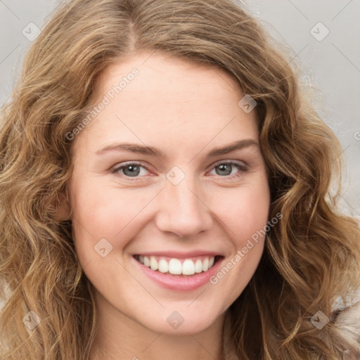 Joyful white young-adult female with long  brown hair and green eyes