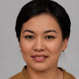 Joyful asian young-adult female with short  black hair and brown eyes