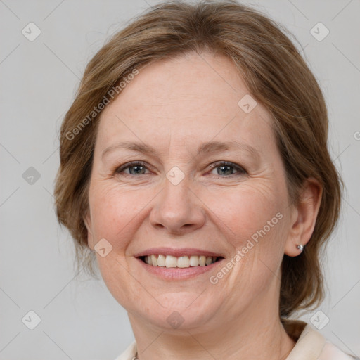 Joyful white adult female with medium  brown hair and grey eyes