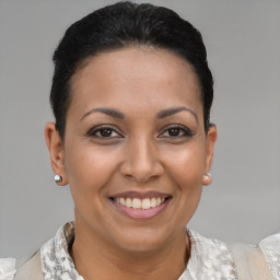 Joyful latino young-adult female with short  brown hair and brown eyes
