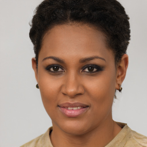 Joyful black young-adult female with short  brown hair and brown eyes