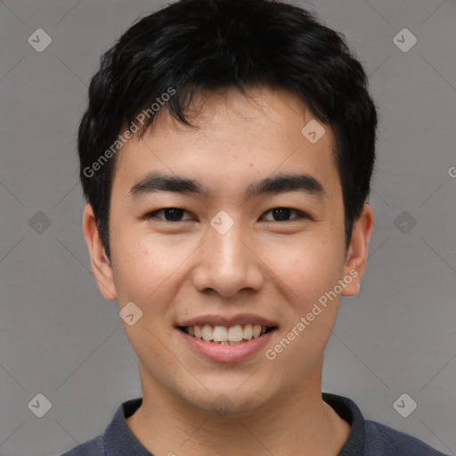 Joyful asian young-adult male with short  black hair and brown eyes