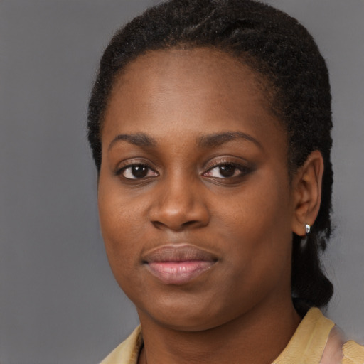 Joyful black young-adult female with short  brown hair and brown eyes