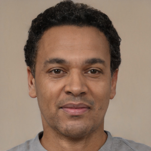Neutral latino adult male with short  black hair and brown eyes