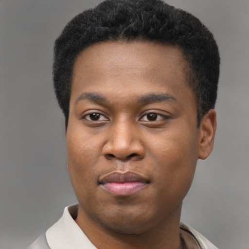 Joyful black young-adult male with short  brown hair and brown eyes