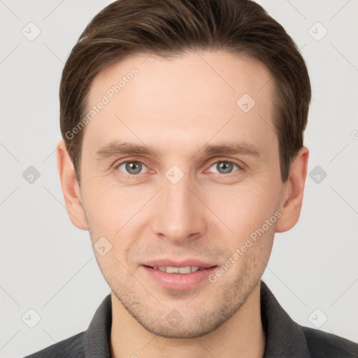 Joyful white young-adult male with short  brown hair and grey eyes