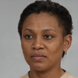 Joyful black adult female with short  brown hair and brown eyes