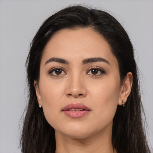 Joyful latino young-adult female with long  brown hair and brown eyes