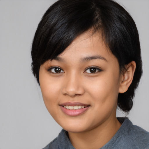 Joyful asian young-adult female with medium  black hair and brown eyes