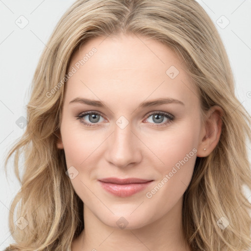 Joyful white young-adult female with long  brown hair and blue eyes