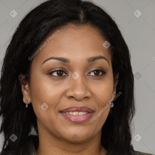 Joyful black young-adult female with long  brown hair and brown eyes