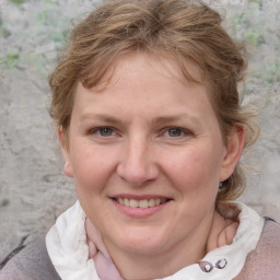 Joyful white adult female with medium  brown hair and blue eyes