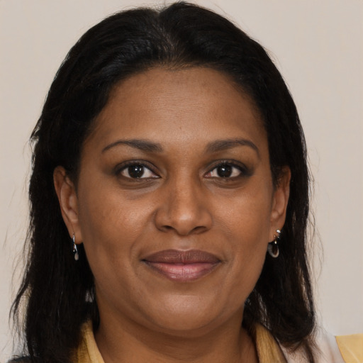 Joyful black adult female with medium  brown hair and brown eyes