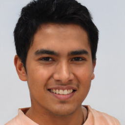 Joyful asian young-adult male with short  black hair and brown eyes