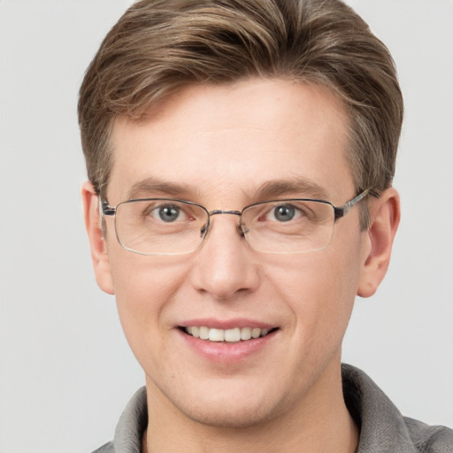 Joyful white adult male with short  brown hair and grey eyes