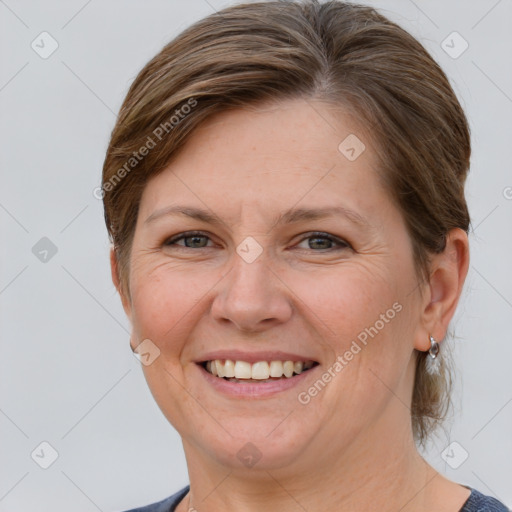 Joyful white adult female with medium  brown hair and grey eyes