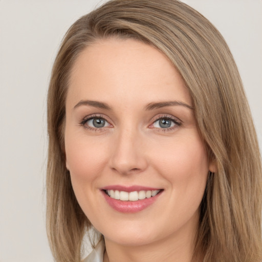 Joyful white young-adult female with long  brown hair and green eyes