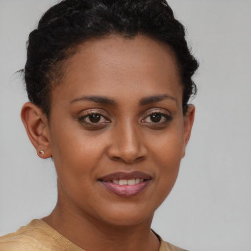 Joyful black young-adult female with short  brown hair and brown eyes