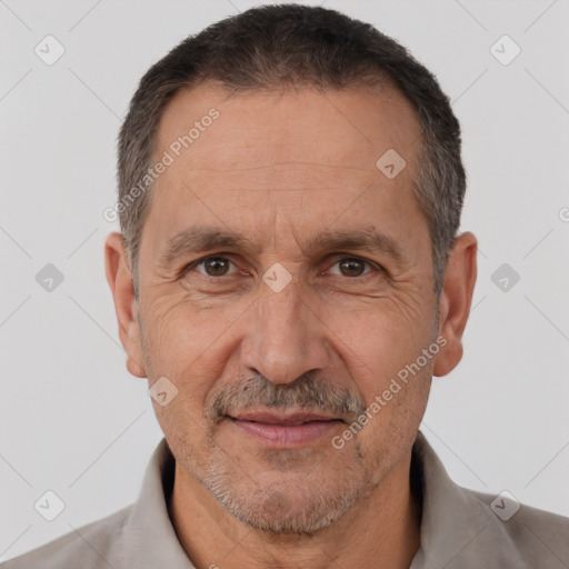 Joyful white adult male with short  brown hair and brown eyes