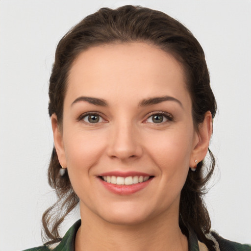 Joyful white young-adult female with long  brown hair and grey eyes