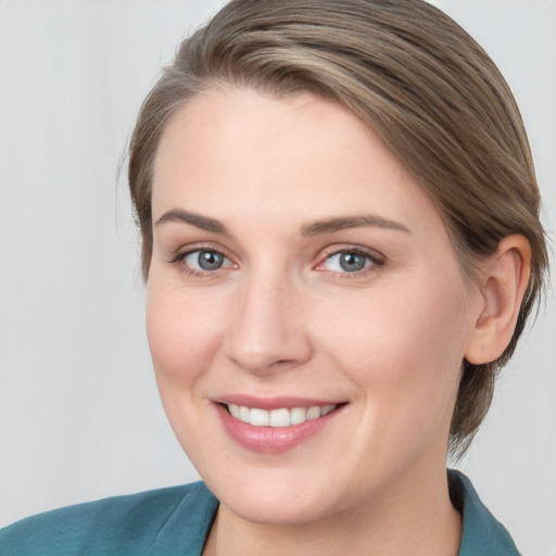 Joyful white young-adult female with medium  brown hair and blue eyes