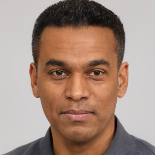Joyful latino adult male with short  black hair and brown eyes