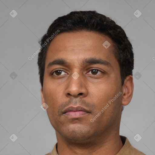Neutral latino young-adult male with short  black hair and brown eyes