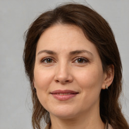 Joyful white adult female with medium  brown hair and brown eyes