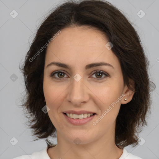 Joyful white adult female with medium  brown hair and brown eyes