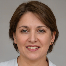 Joyful white adult female with medium  brown hair and brown eyes