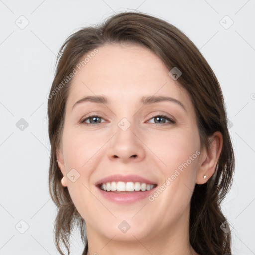 Joyful white young-adult female with medium  brown hair and grey eyes