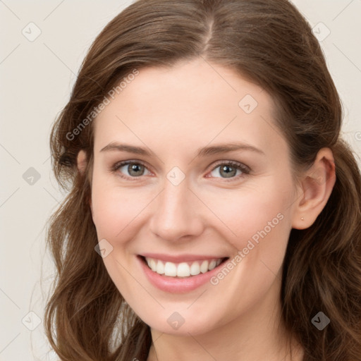 Joyful white young-adult female with long  brown hair and green eyes