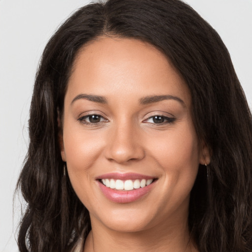 Joyful white young-adult female with long  brown hair and brown eyes