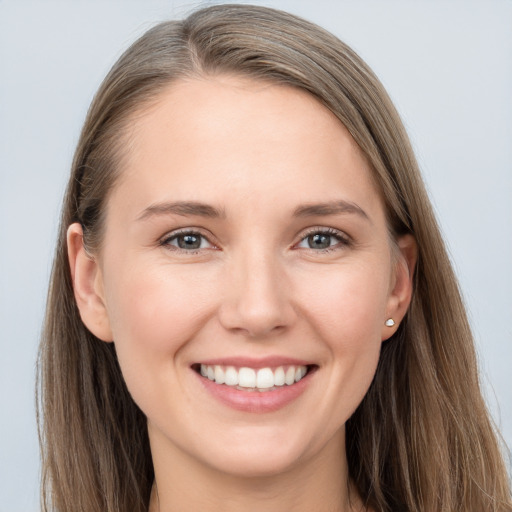 Joyful white young-adult female with long  brown hair and grey eyes