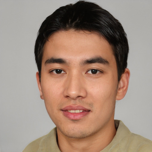 Joyful asian young-adult male with short  black hair and brown eyes