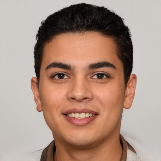 Joyful latino young-adult male with short  brown hair and brown eyes