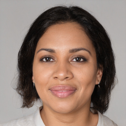 Joyful black young-adult female with medium  brown hair and brown eyes