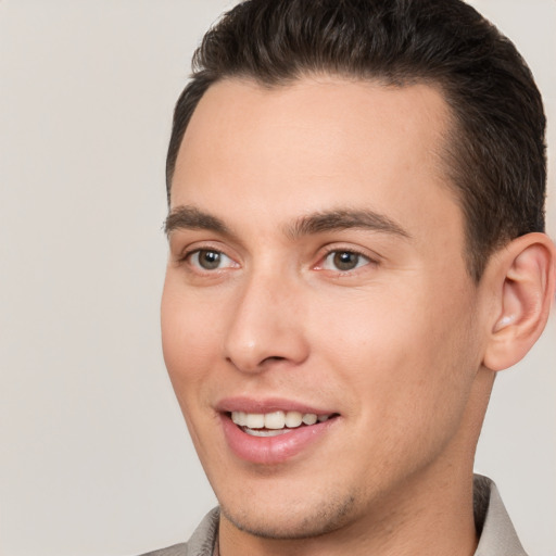 Joyful white young-adult male with short  brown hair and brown eyes