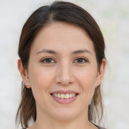 Joyful white young-adult female with medium  brown hair and brown eyes