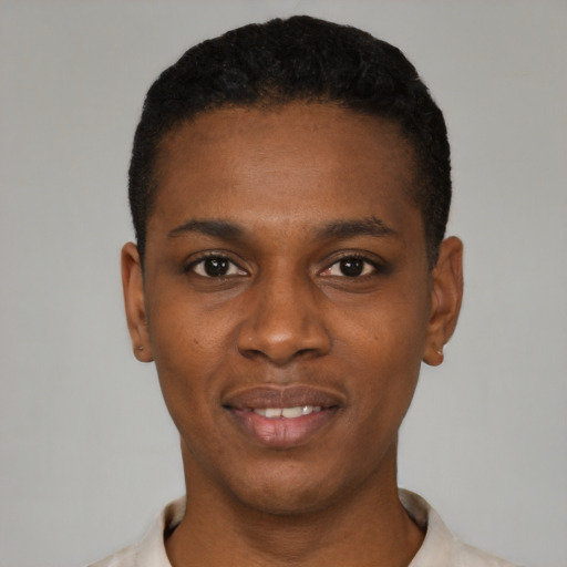 Joyful black young-adult male with short  black hair and brown eyes