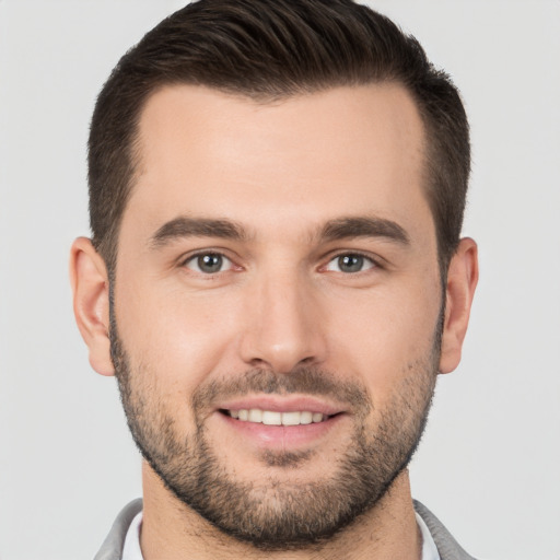 Joyful white young-adult male with short  brown hair and brown eyes